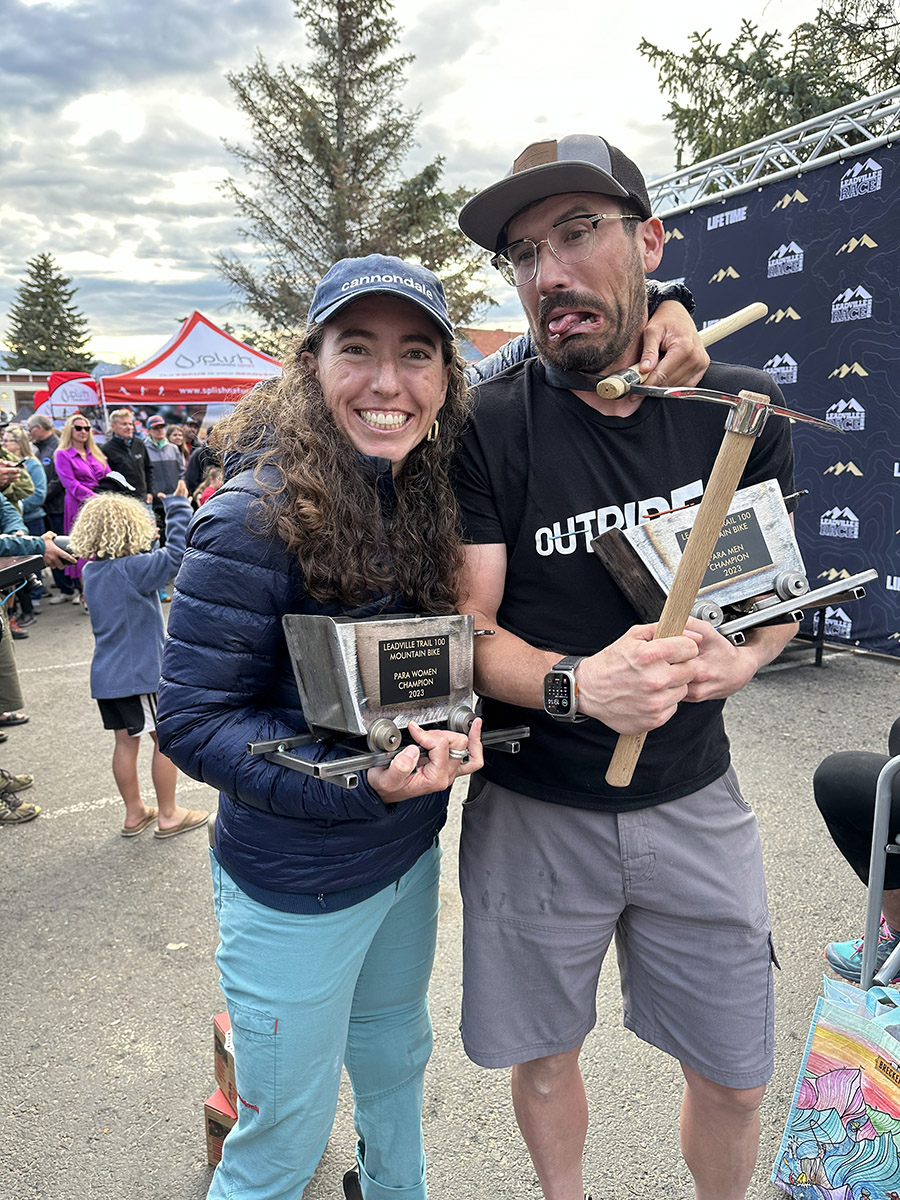 Steven holding a wooden trophy after the Leadville Trail 100 MTB